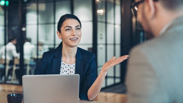 Female office worker talking to coworker